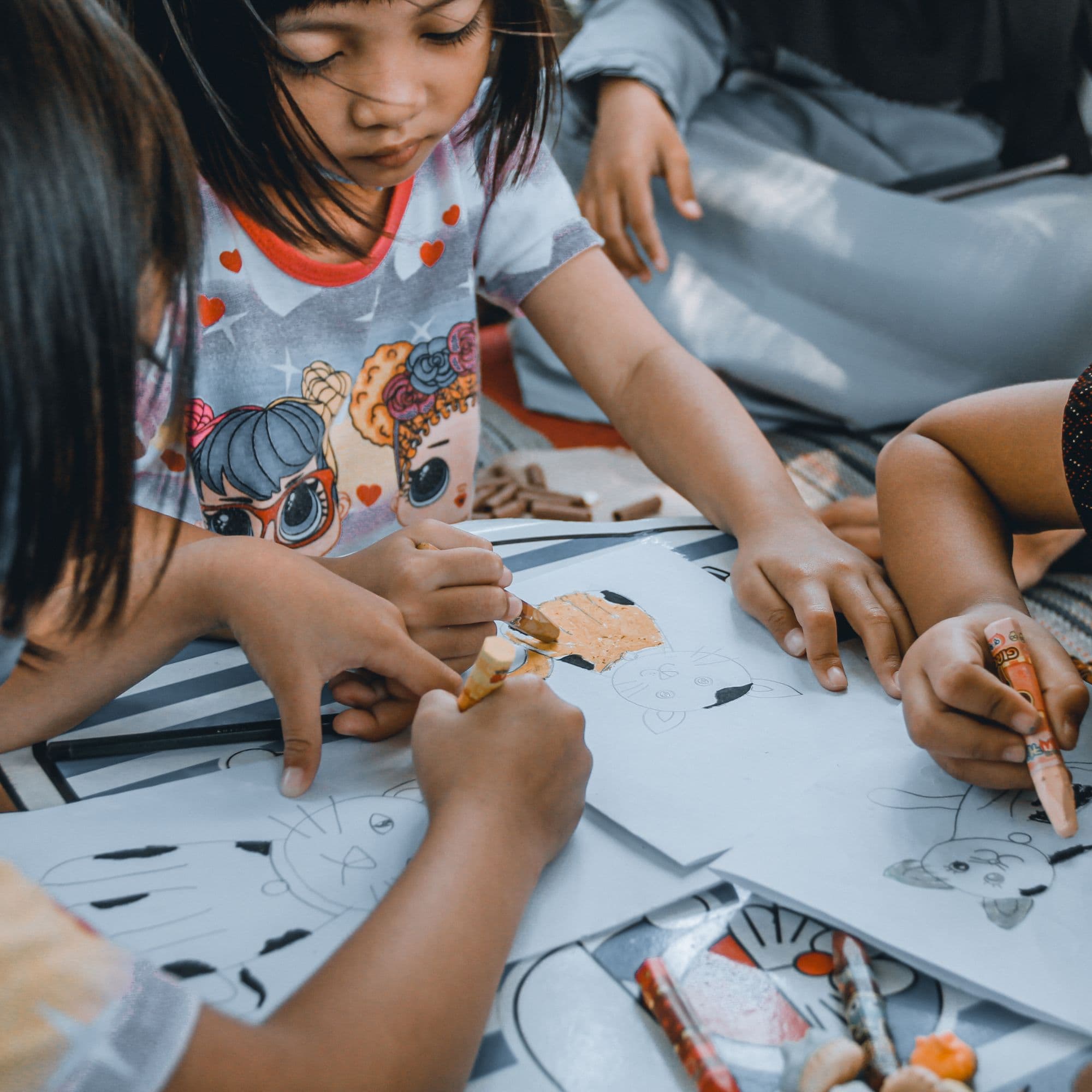 Children creating art together at a table