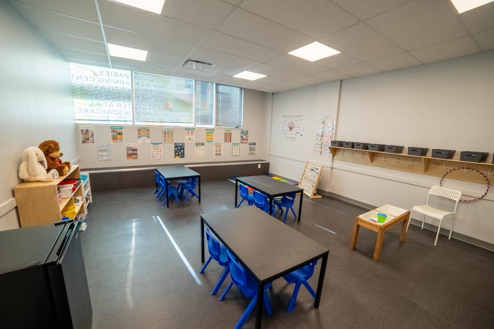 Preschool classroom with tables and activity stations